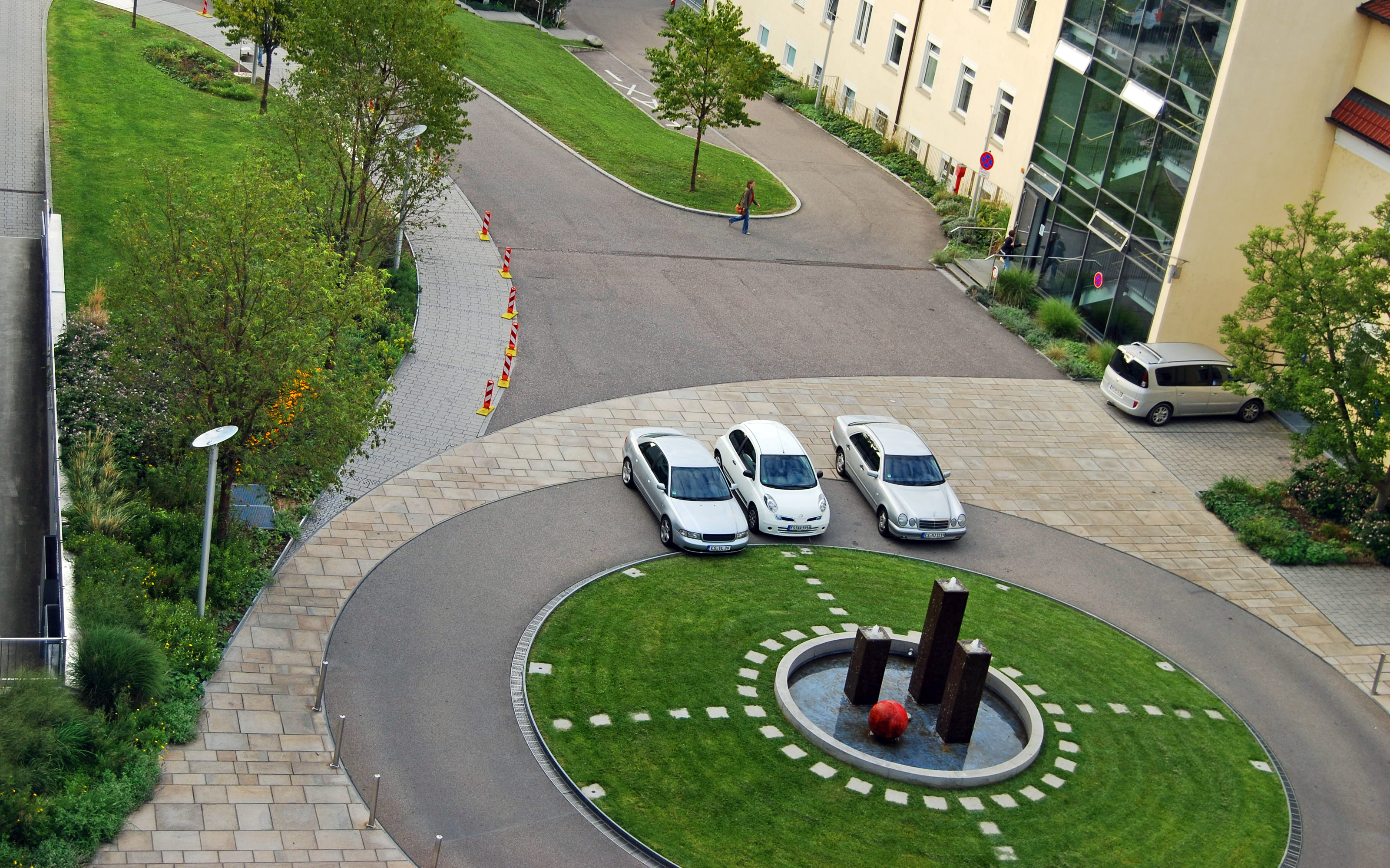 Vista de pájaro de la rotonda verde y coches